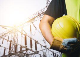 An,Electrician,Wearing,A,Black,T-shirt,And,A,Reflective,Vest.
